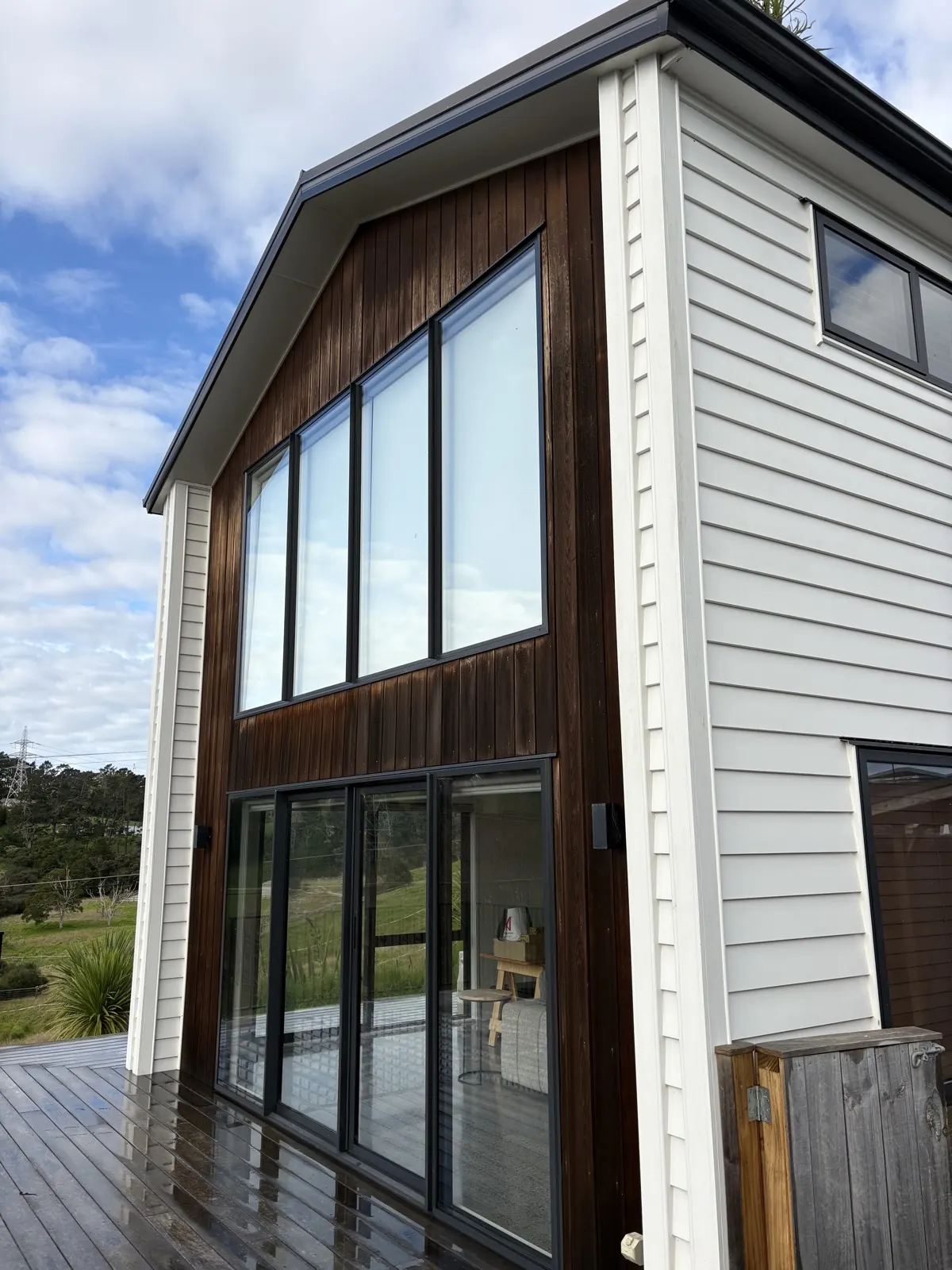 Cedar and white weatherboard two-storey home after a soft wash, West Auckland