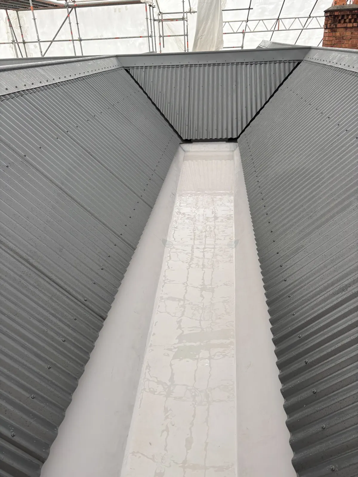 Clean roof valley and corrugated metal roofing after washing